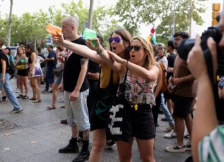 Barcelona anti-tourism protesters spray visitors with water guns