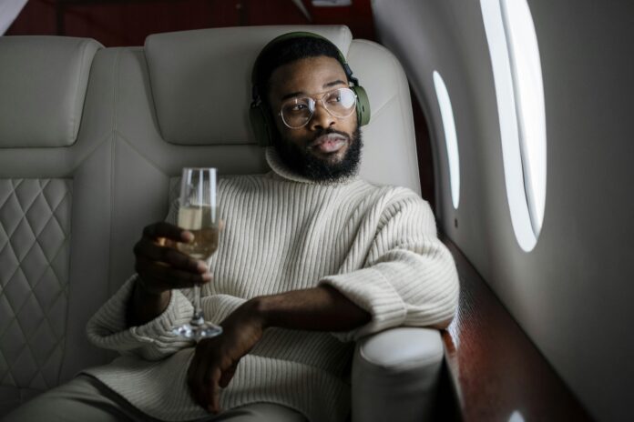 https://www.pexels.com/photo/man-inside-an-airplane-holding-a-champagne-glass-6700123/