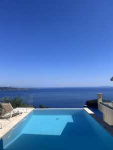 Sunset view from Villa Bliss Corfu terrace with gyros and Mythos beer